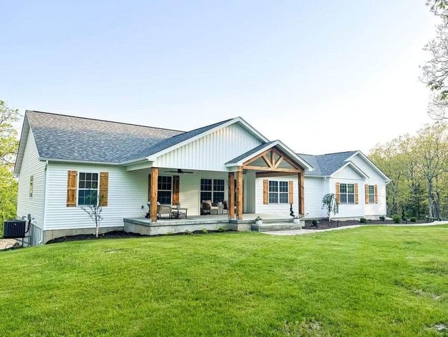 White Siding With Wooden Shutters
