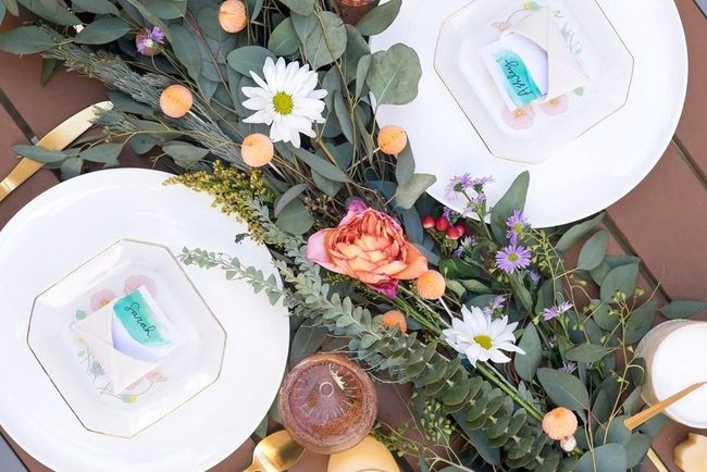 Gold-Rimmed Plates With Wildflower Centerpieces