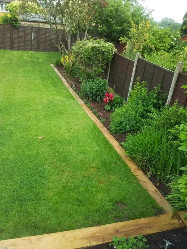 Fenced Lawn With Flowering Borders