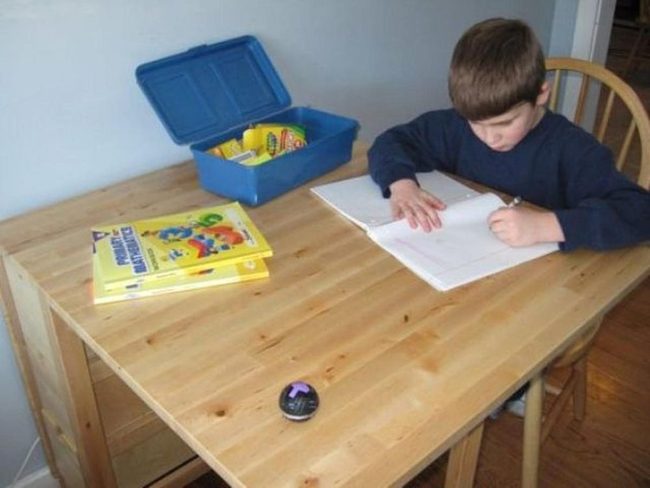 Boy With Crayons And Wooden Desk
