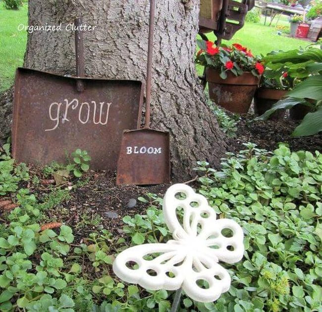 Butterfly Statues Among Growing Flowers