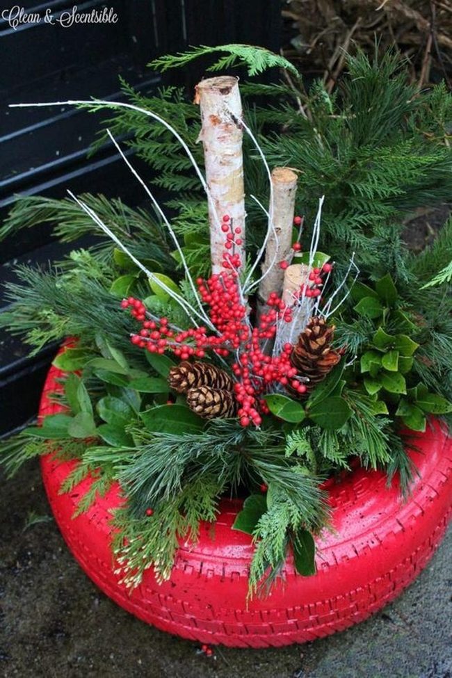 Red Tire Planter With Evergreen Branches