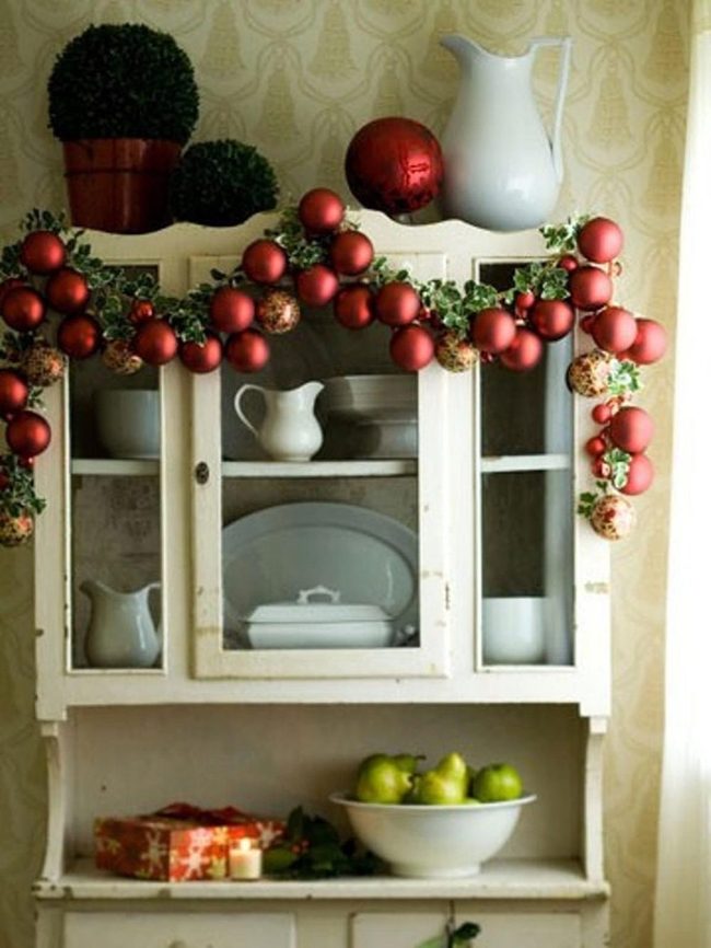 White Wood Cabinet, Green Plants, Red Accents