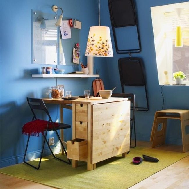 Wooden Table, Green Rug, Blue Walls