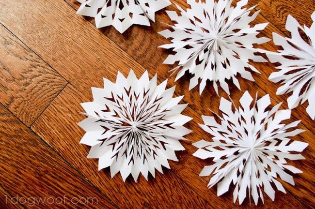 White Paper Snowflakes On Wood