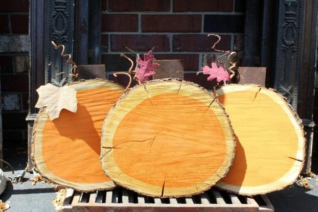 Wooden Pumpkins Against Dark Brick