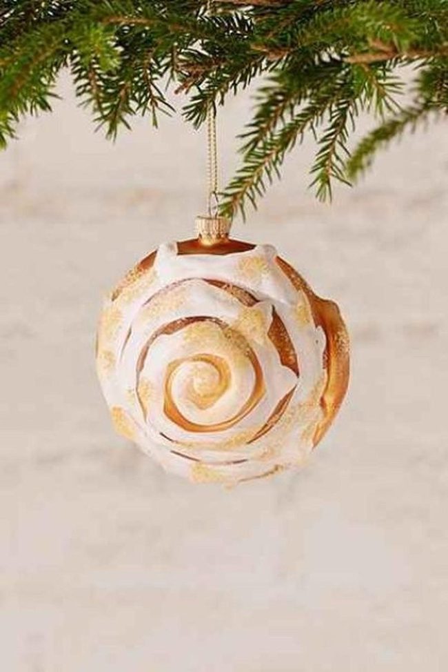 Frosted Gold Ornament Among Evergreen
