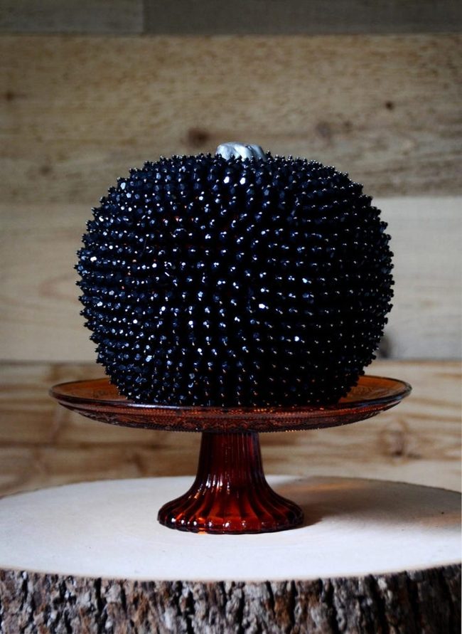 Black Pumpkins On Amber Glass