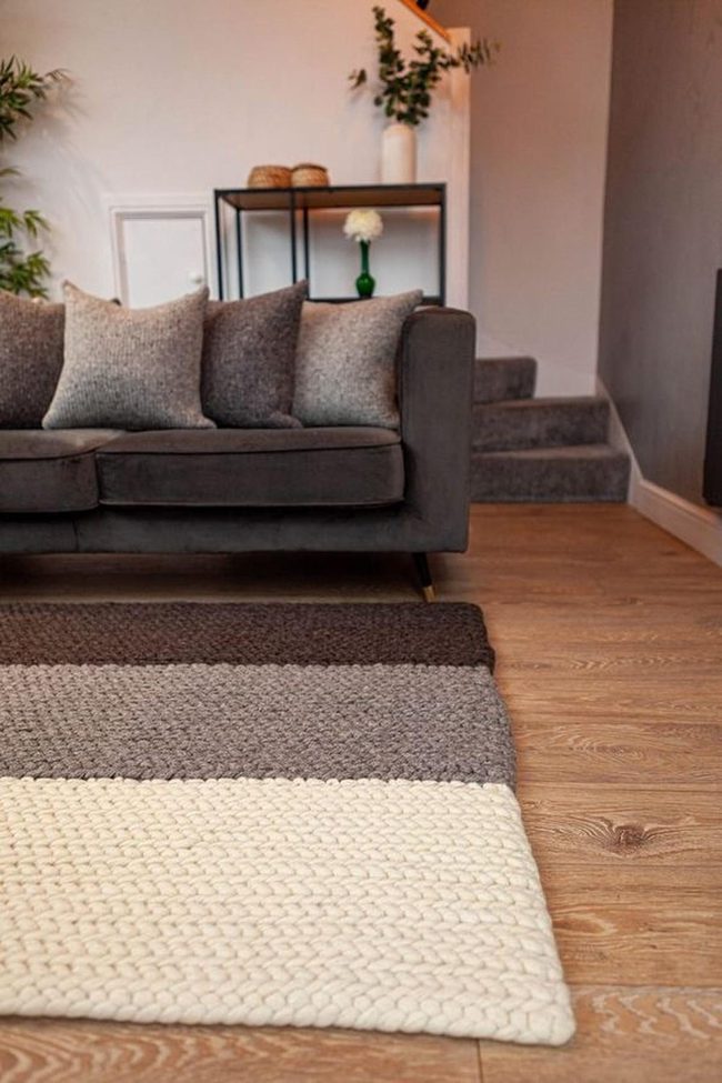 Gray Sofa With Cream Striped Rug