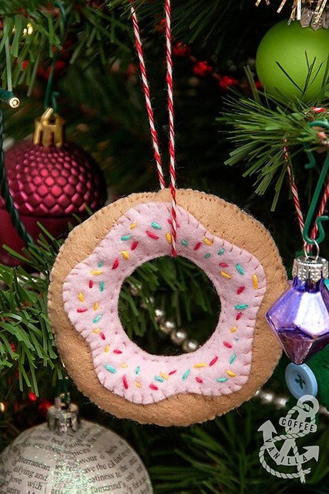 Pink Felt Donut Among Evergreen Branches