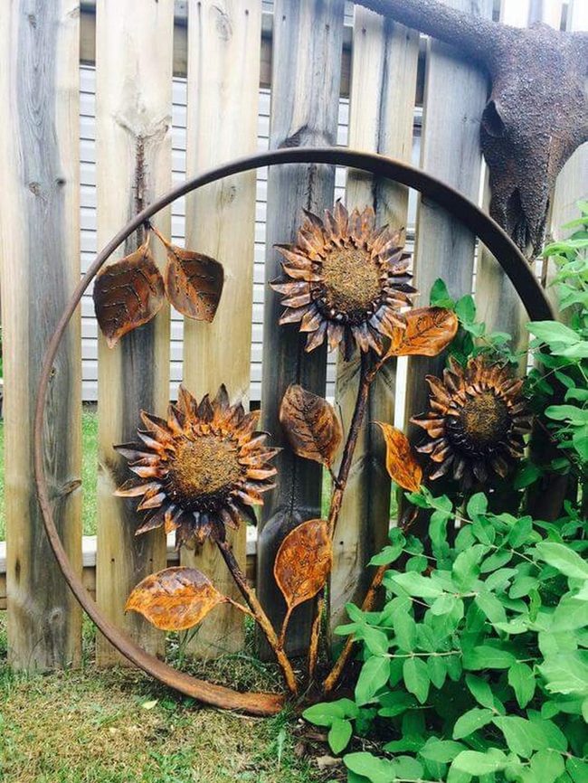 Metal Sunflowers Against Weathered Wood