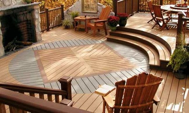 Curved Wooden Deck With Stone Fireplace