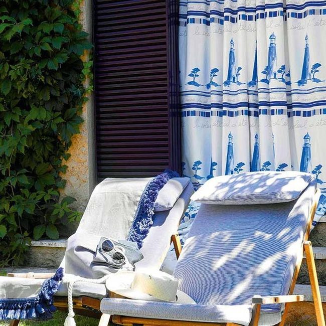 Blue-Fringed White Loungers By The Sea