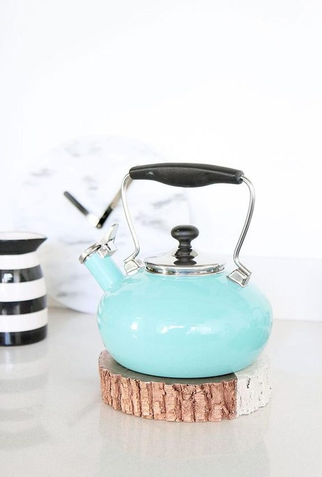 Turquoise Metal Kettles On Wood