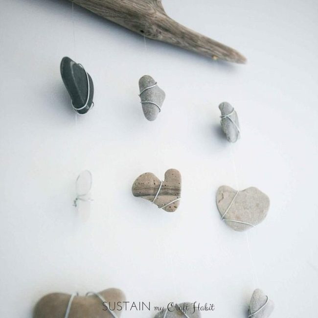 Suspended Gray Stones On Driftwood