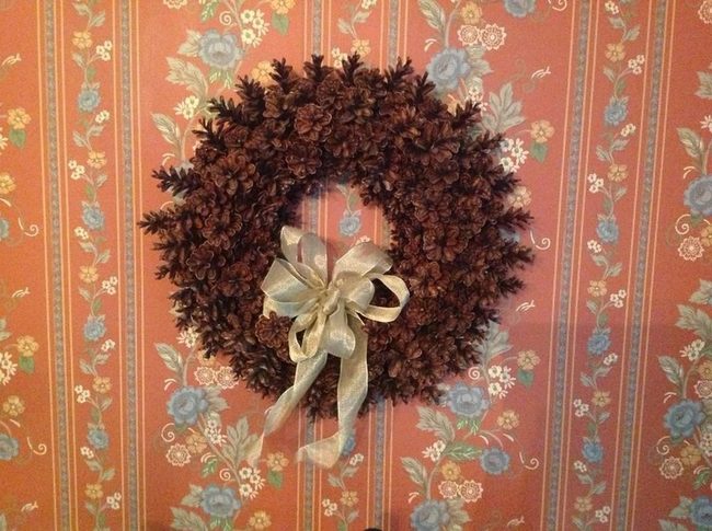 Orange Floral Walls With Pine Cone Wreath