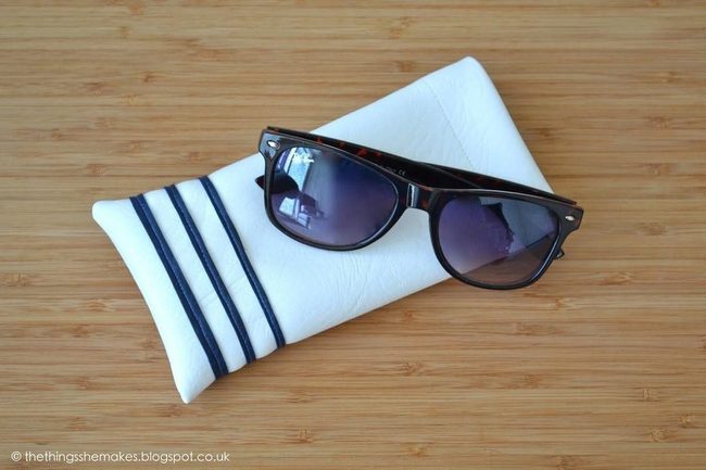 Dark Sunglasses On Striped Linen