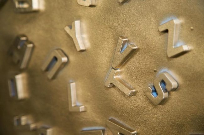 Metallic Letters On Textured Walls