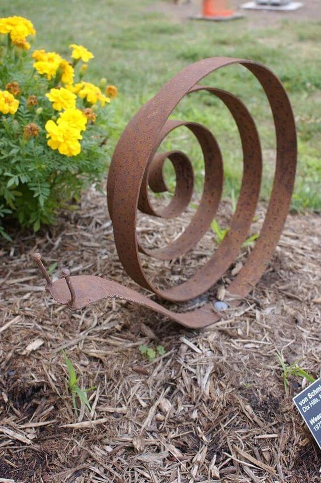 Metal Snail Among Golden Marigolds