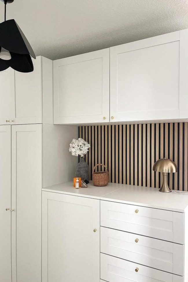 White Cabinetry With Gold Lamp