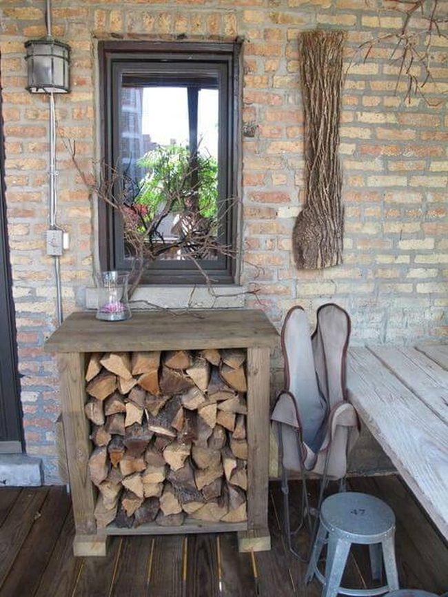 Stacked Logs Against Brick