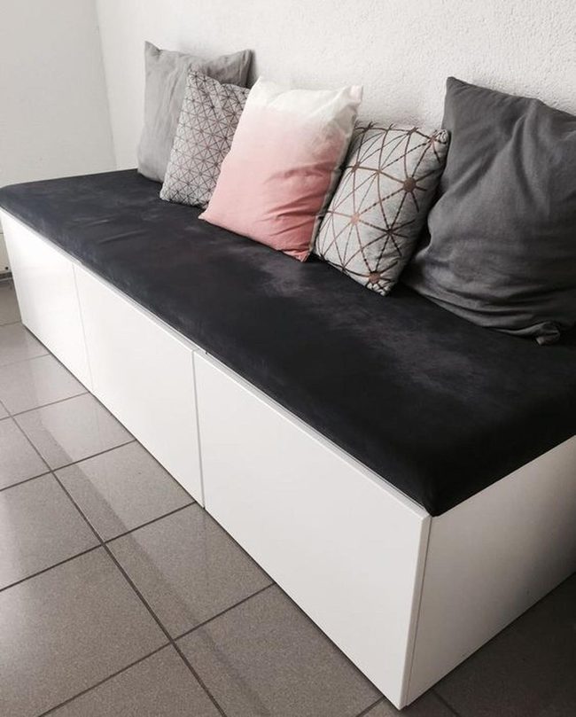 Black Cushioned Bench With Geometric Pillows
