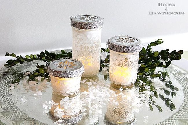 Silver-Rimmed Candles With Winter Greenery