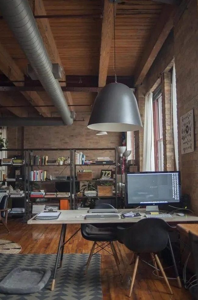 Black Pendant Over Brick Workspace
