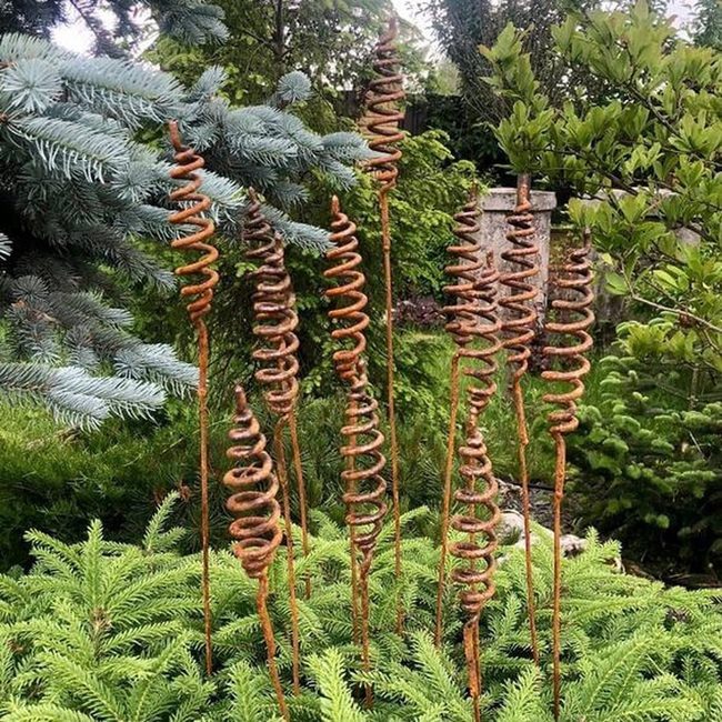 Rusted Metal Spirals Through Green
