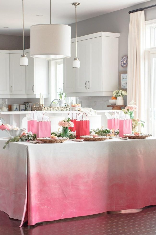 White Cabinetry With Pink Tablecloth Accents