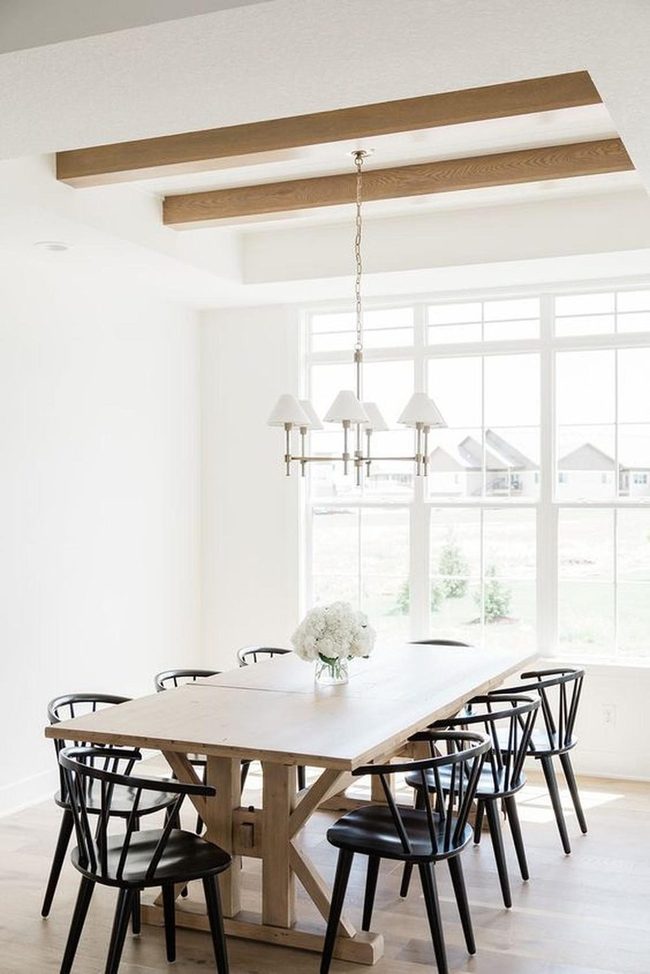 Sunlit Wooden Dining With Black Chairs