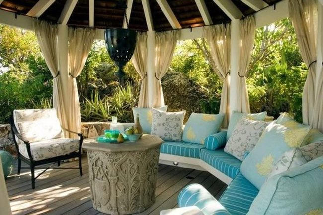 Sunlit Wooden Patio With Blue Cushions
