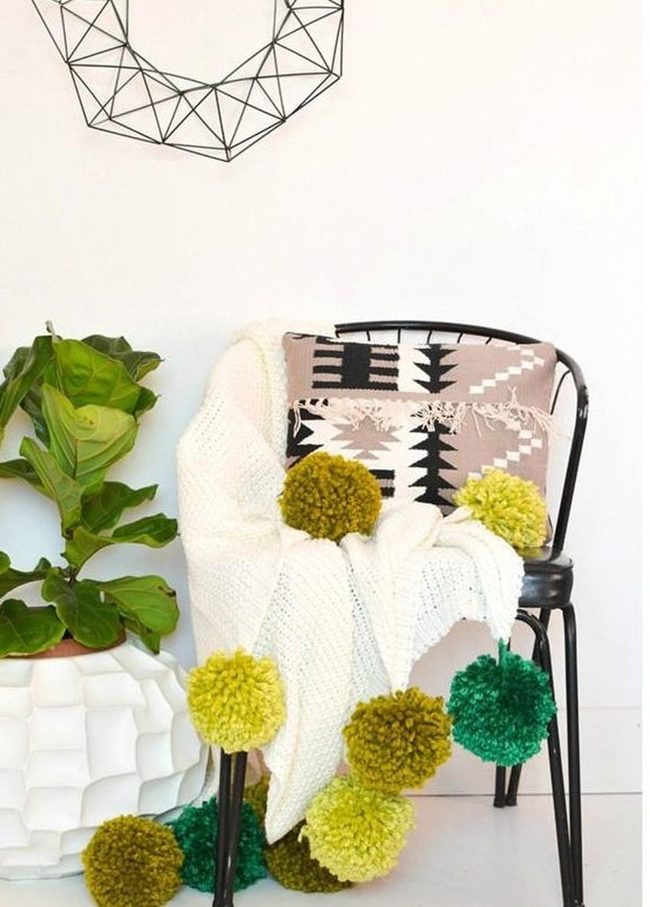 Black Metal Chair With Pom-Pom Blanket