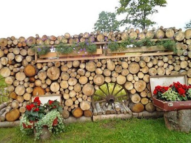 Stacked Logs With Wildflowers
